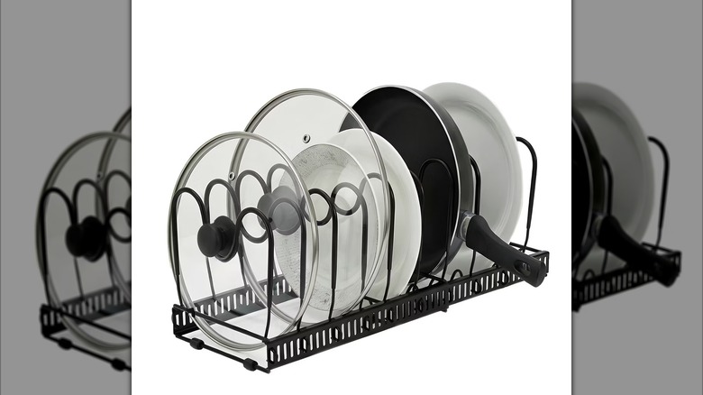 The Garvee Black Metal Pot Lid Holder Adjustable Kitchen Cabinet Organizer Rack from Target on a white background.