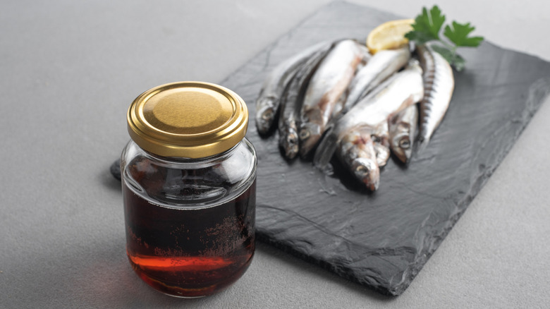 Fish on a piece of slate and a jar of garum