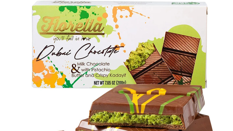 Box of Fiorella Dubai chocolate bars with broken bar next to it on white background