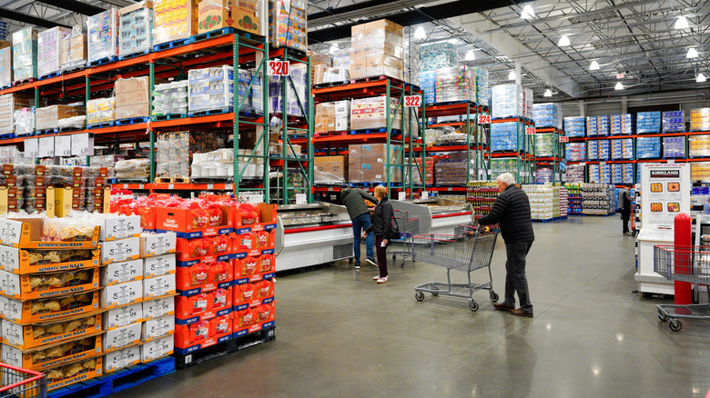Costco shopper pushing a cart inside the store