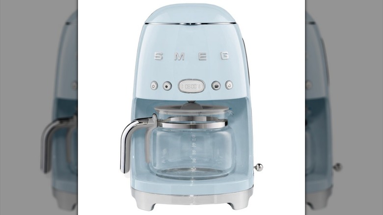 A blue vintage-style drop coffee machine with a SMEG logo on a white background.