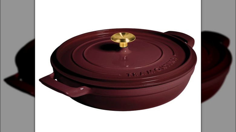 A red cast iron enameled braiser from Tramontina on a white background.