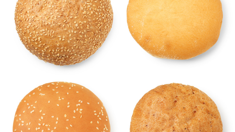Different burger buns isolated on white, top view