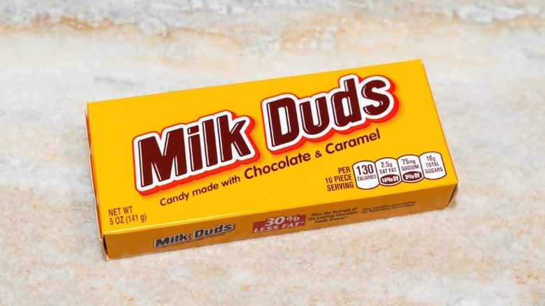 A box of Milk Duds sitting on a counter top.