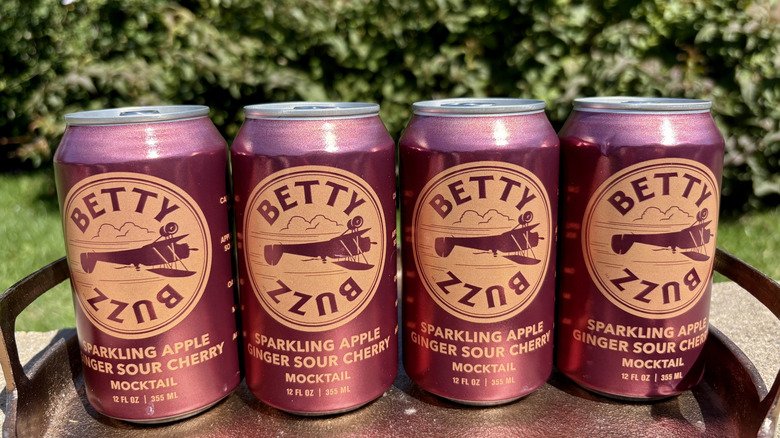 Cans of Betty Buzz Sparkling Apple Ginger Sour Cherry Mocktail