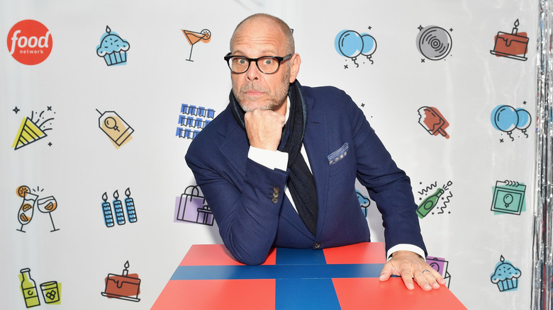 Alton Brown posing with his fist under his chin