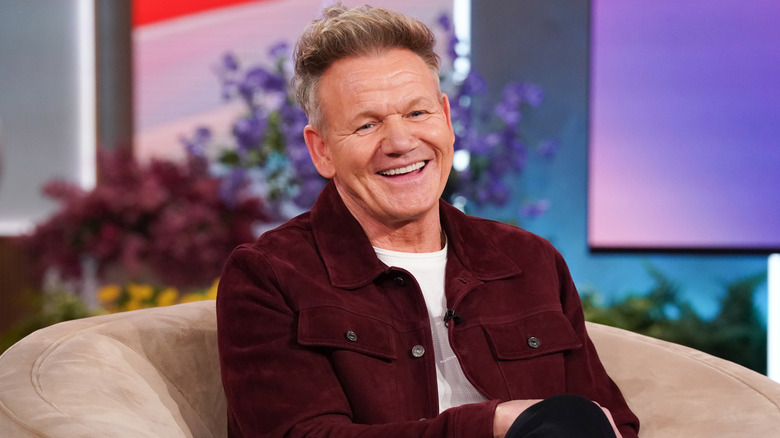 Gordon Ramsay sitting in a chair and laughing