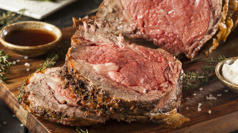 Sliced prime rib roast on wooden cutting board