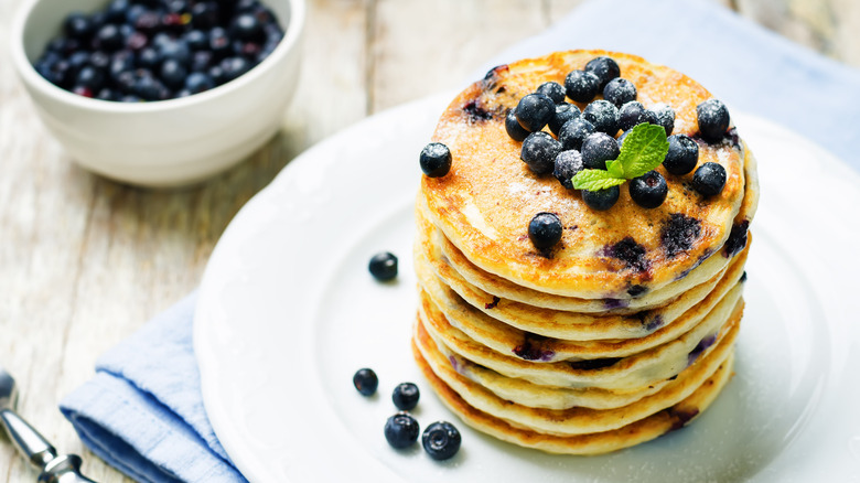 A stack of blueberry pancakes on a plate