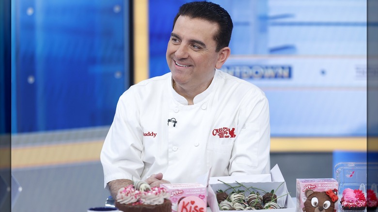 Buddy Valastro in a chef's coat on a TV set
