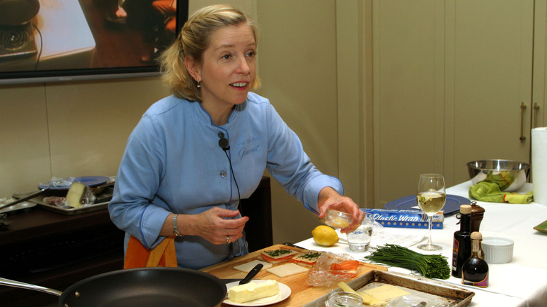 Sara Moulton behind a counter cooking on TV