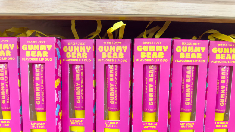 Little boxes of Trader Joe's gummy bear lip butter lined up on store shelf