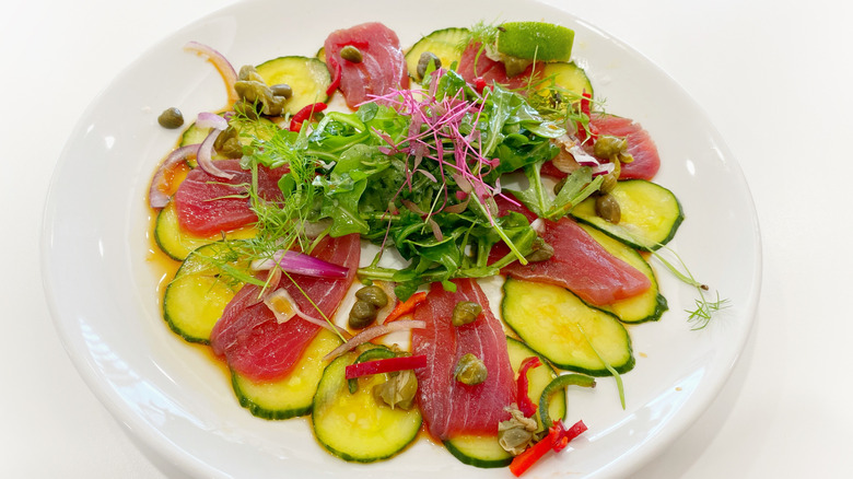 Plate of tuna crudo with fresh vegetables