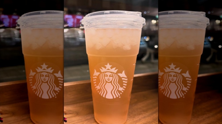 An orange colored iced tea Starbucks drink