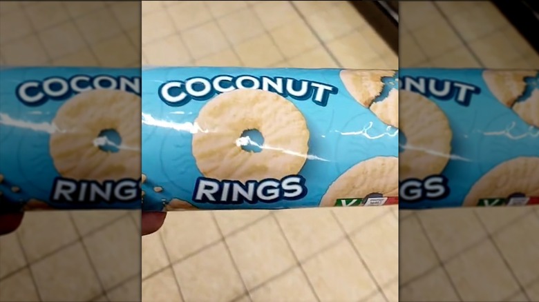 A package of Belmont coconut rings being held by a hand out of frame