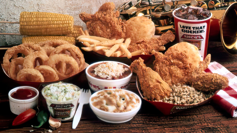 An old photo showing a display of Popeyes fried chicken and sides