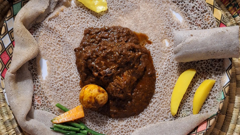 Doro wat Ethiopian chicken stew on large piece of injera