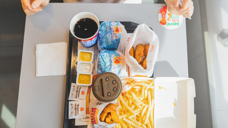 Overhead shot of a tray filled with various Burger King foods and drinks.