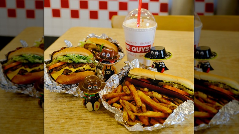 A Five Guys meal and shake on a table in a restaurant