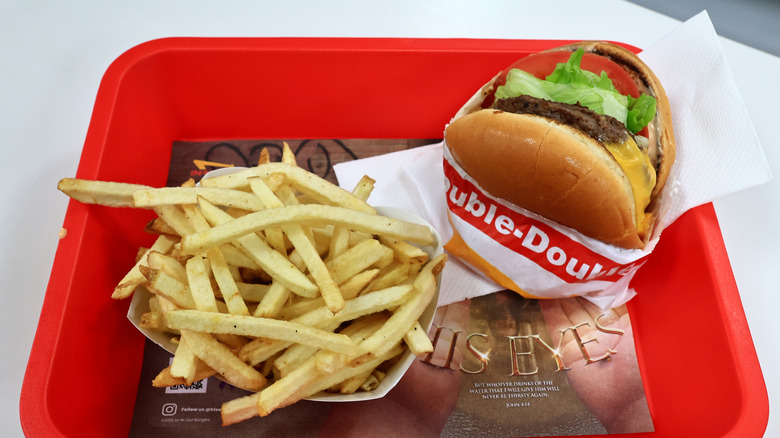A tray with an In-N-Out double burger and fries on it.