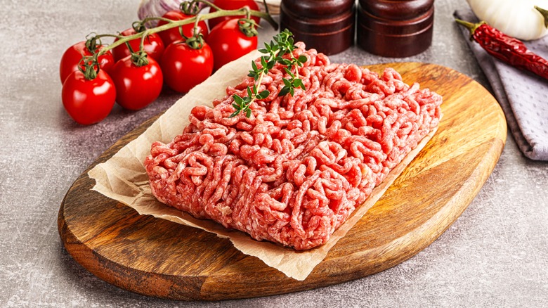 Raw ground beef on a wood board