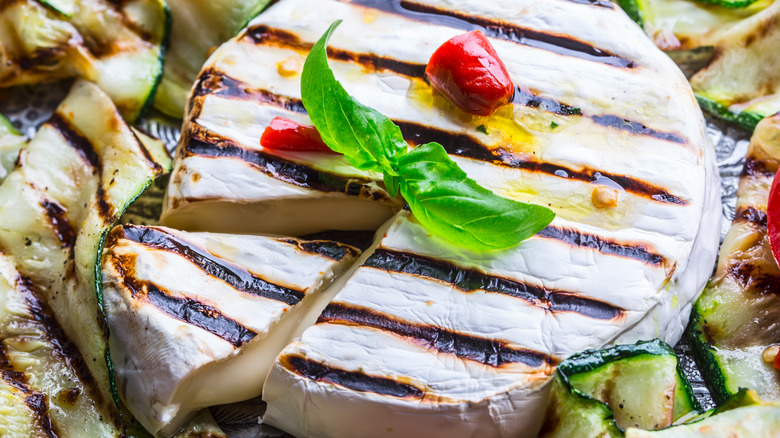 Grilled brie cheese with grilled tomatoes on top