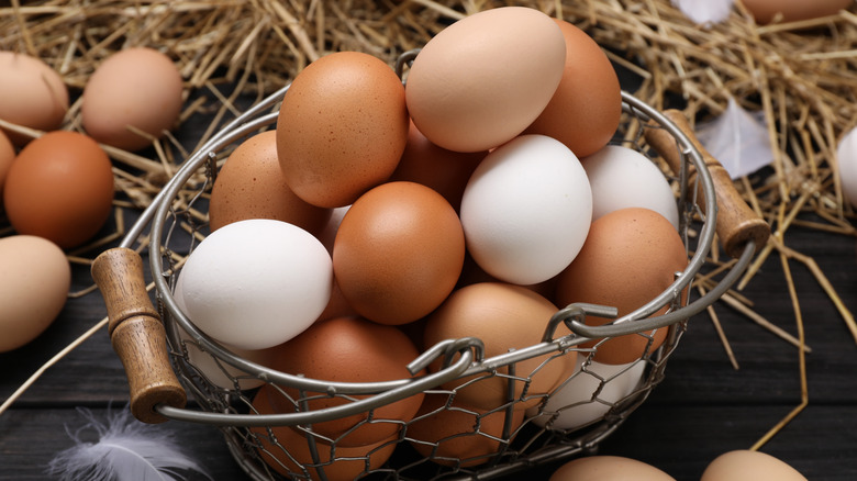 Brown eggs in a metal basket