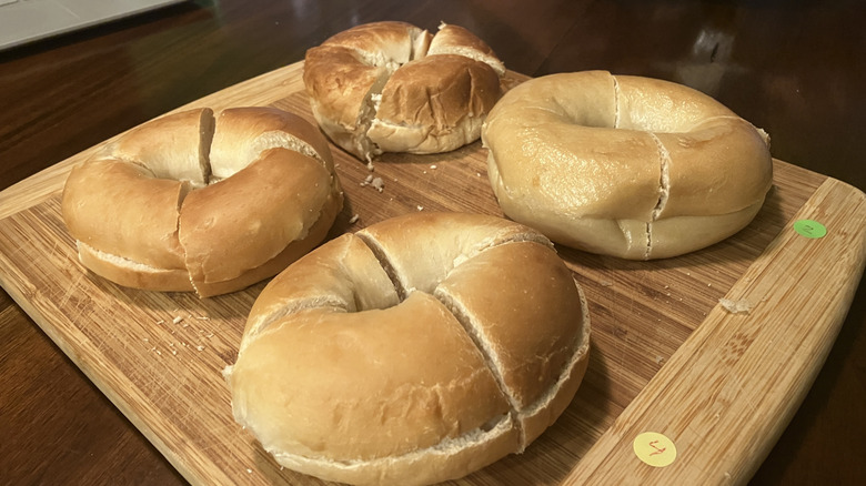 Cut bagels on a numbered bamboo cutting board, ready for a taste test.