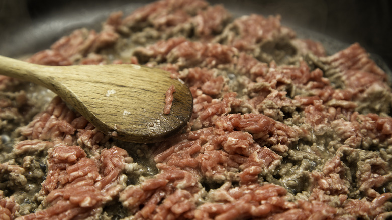 Close-up view of ground meat cooking in a pan