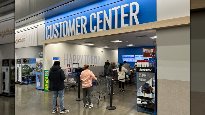 Customers wait in line at a Walmart Customer Center to return items