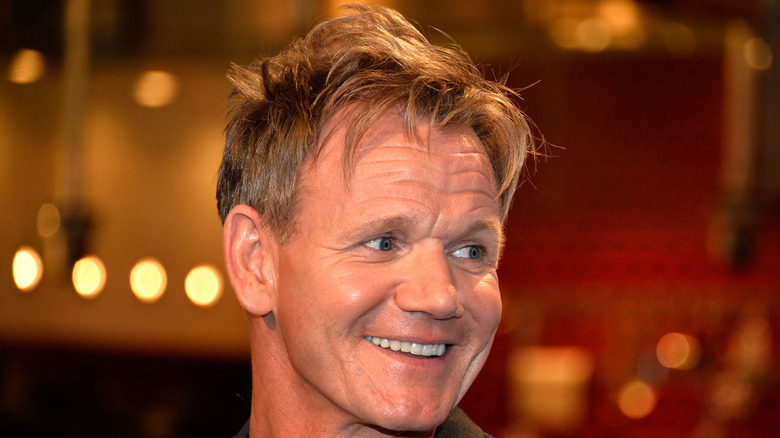 Chef Gordon Ramsay smiling and looking off to the side