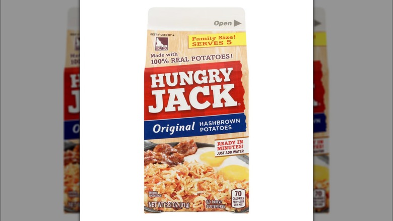 A container of Hungry Jack Original Hashbrown Potatoes on a white background.