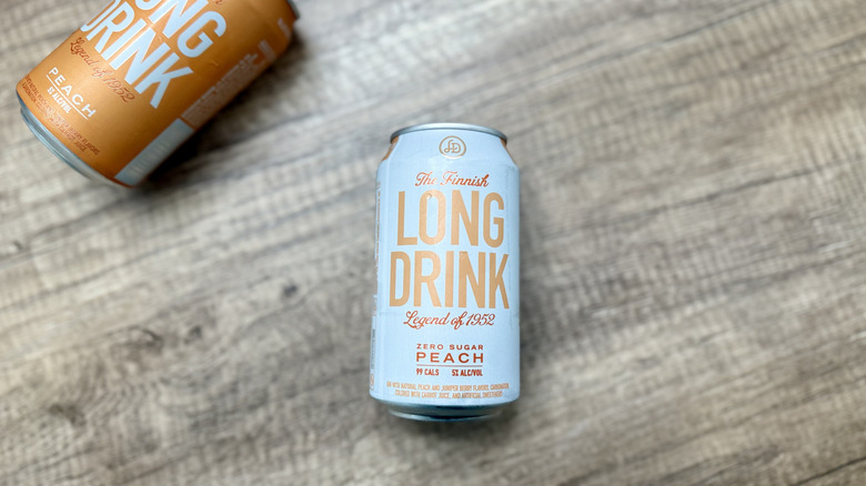 Zero sugar Peach Long Drink with full sugar version of the drink laying on a table