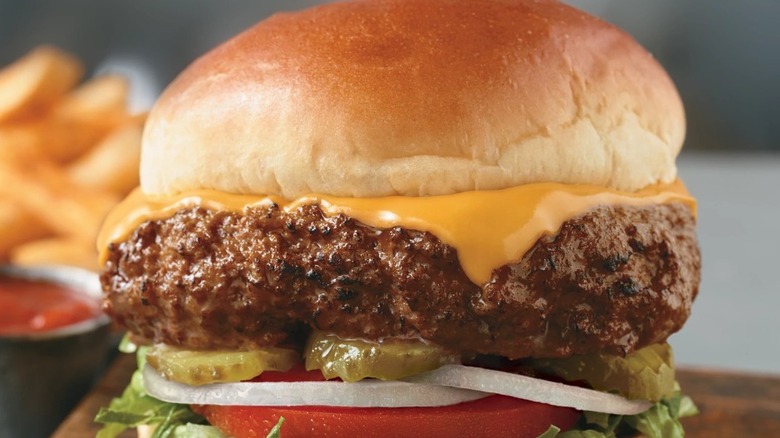 LH Burger with pickles, cheese, tomatoes, onions, and lettuce