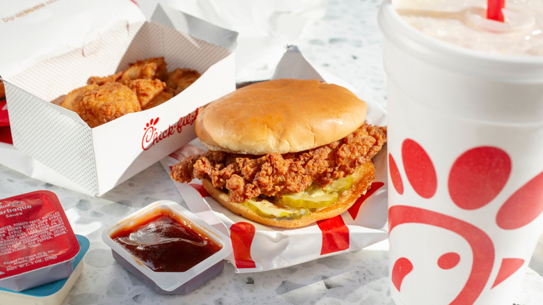 A Chick-fil-A sandwich, nuggets, and drink sits on a countertop