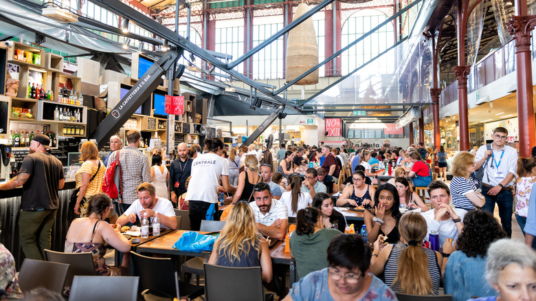 A crowded restaurant with sunlight streaming in