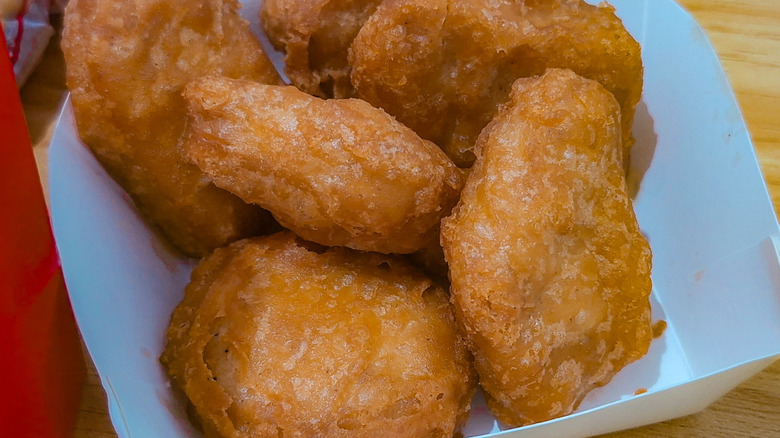 closeup shot of six-piece chicken mcnuggets meal in small takeout box
