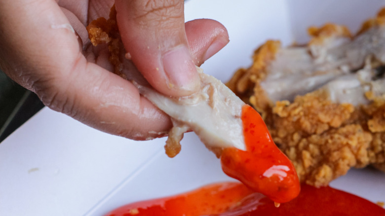 McDonald's crispy strips being dipped in sauce
