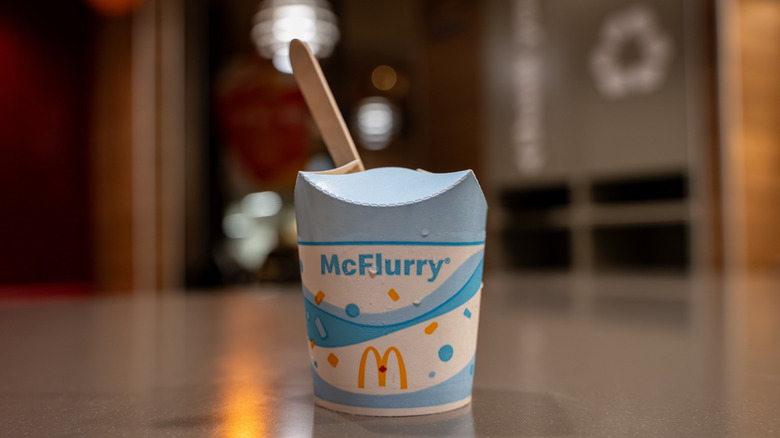 mcflurry cup with wooden spoon against a blurred background