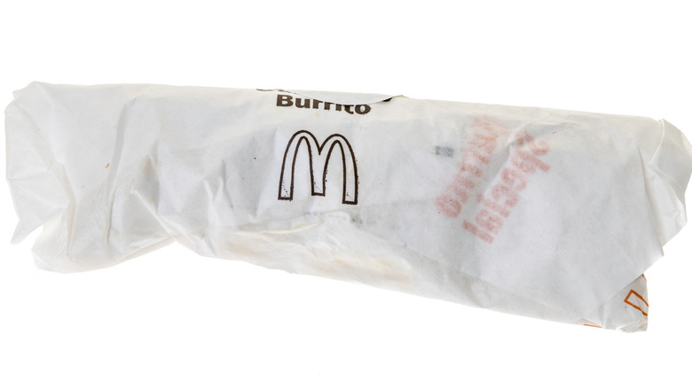 A McDonald's sausage burrito in its wrapper against a white background