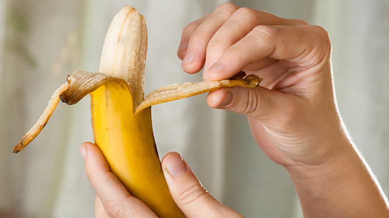 hands holding and peeling a banana