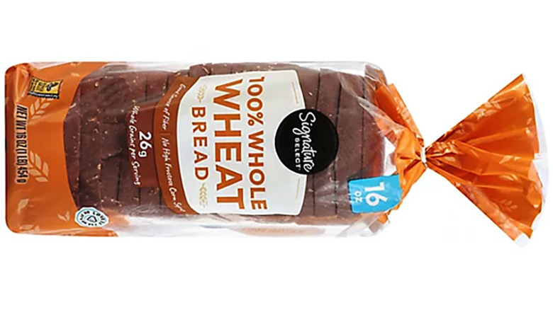 a loaf of Signature Select Bread 100% Whole Wheat