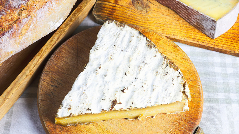 Brie de Meaux cheese on a wooden board