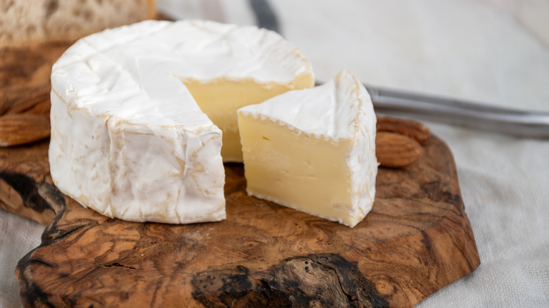 Camembert de Normandie cheese on a wooden board