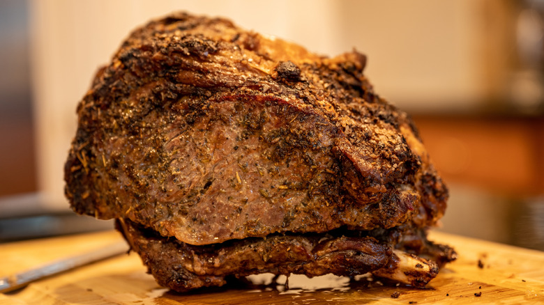 Cooked prime rib resting on a cutting board