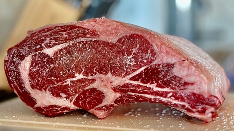 Raw prime rib seasoned with salt