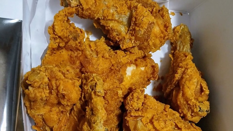 Pieces of Publix fried chicken in a to-go container