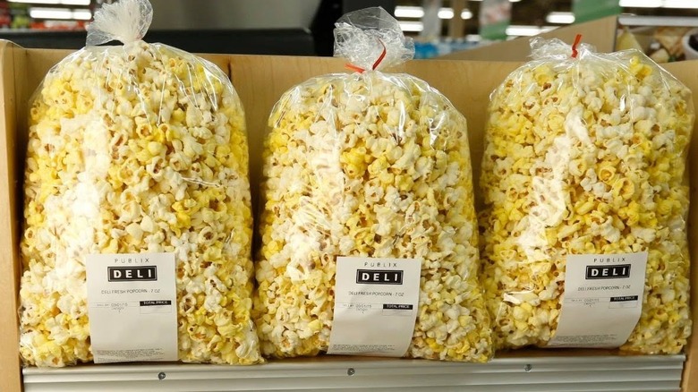 Three large bags of Publix popcorn on display