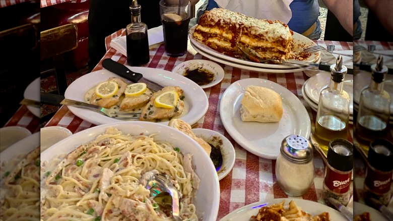 Bowl of pasta and a plate with a stack of lasagna