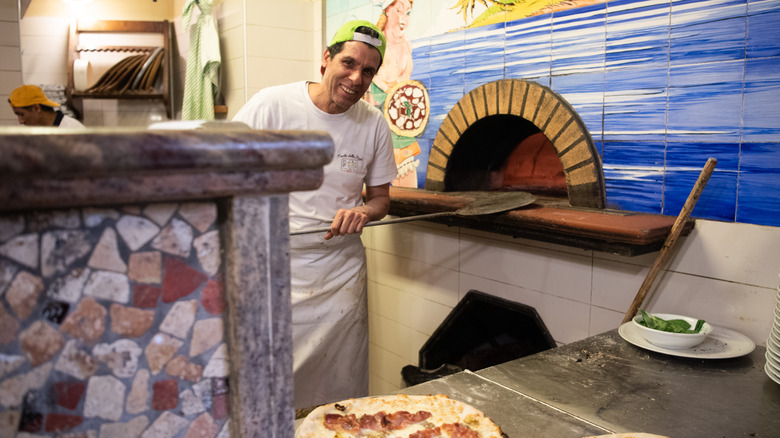 A chef makes pizza at L'Isola della Pizza